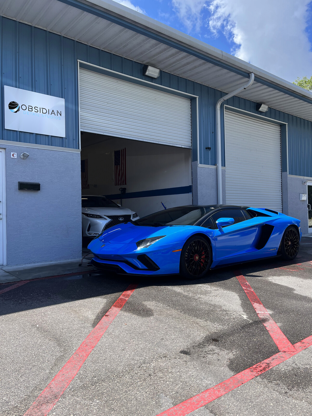 Blue Lamborghini Aventador S outside Obsidian Detail Studios