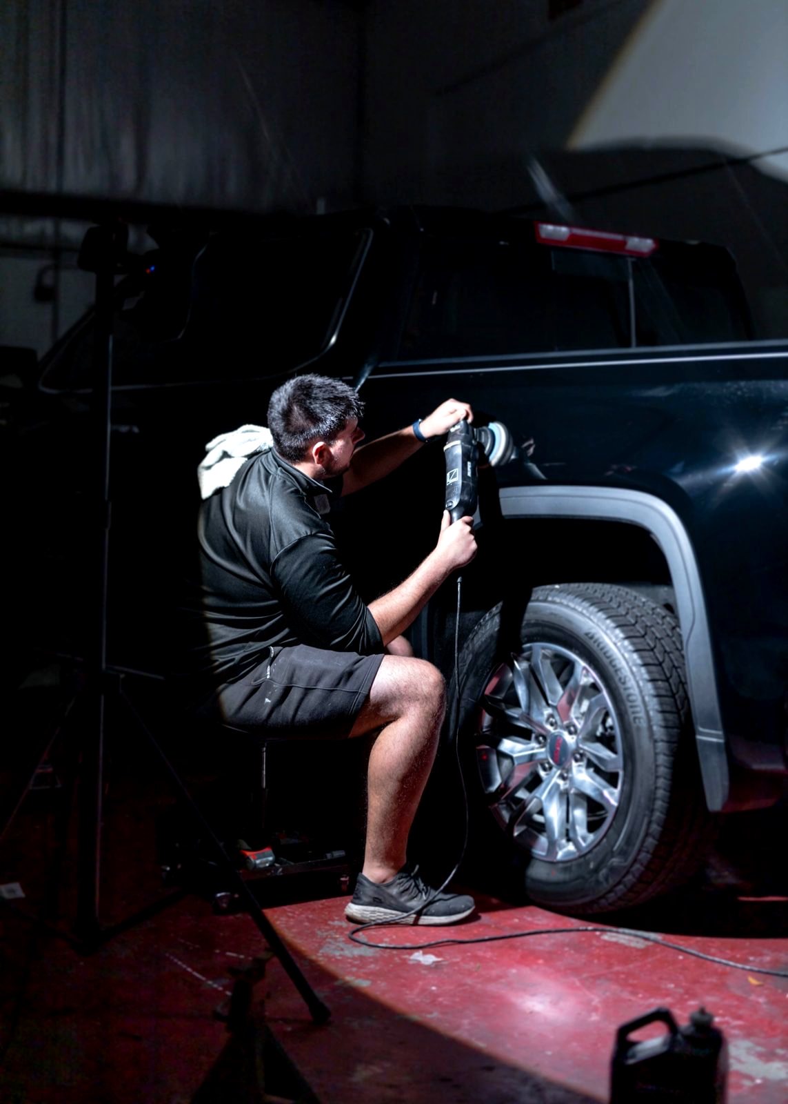 Detailer buffing a truck at Obsidian Detail Studios in Baltimore